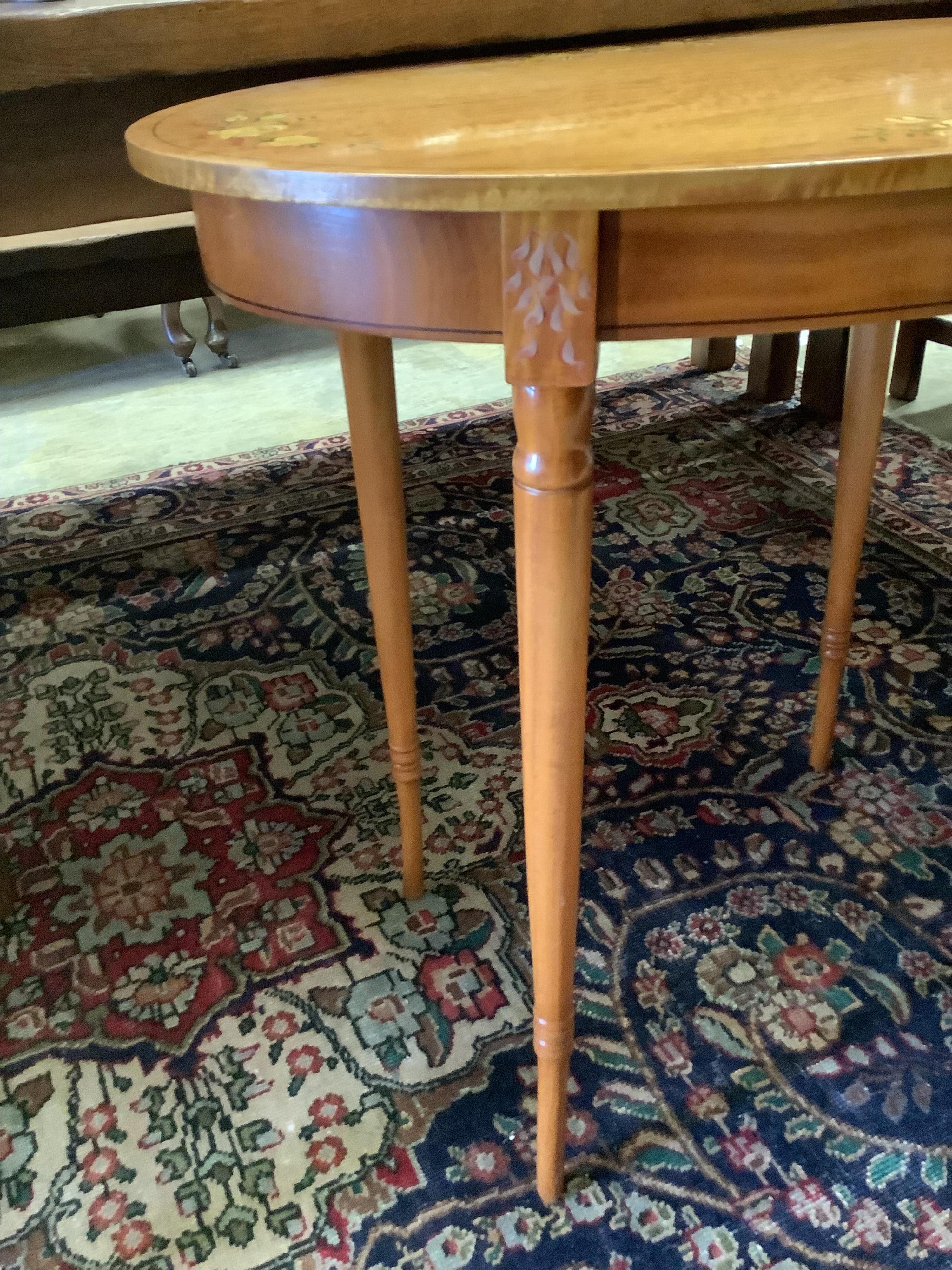 A painted oval satinwood occasional table, width 74cm, depth 51cm, height 70cm